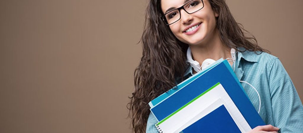 smiling-female-college-student-holding-books